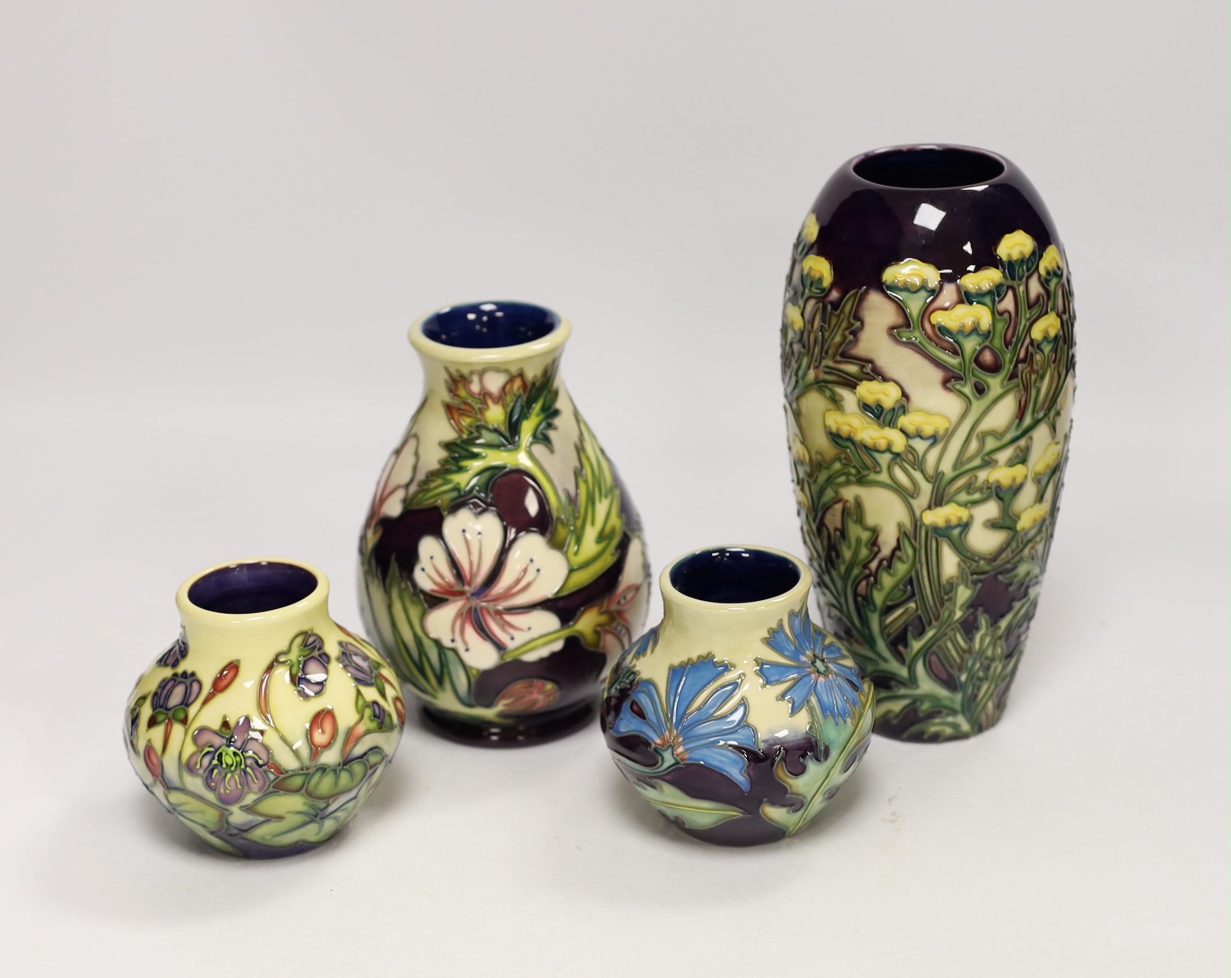 Two squat Moorcroft vases and two larger vases, tallest 19cm high